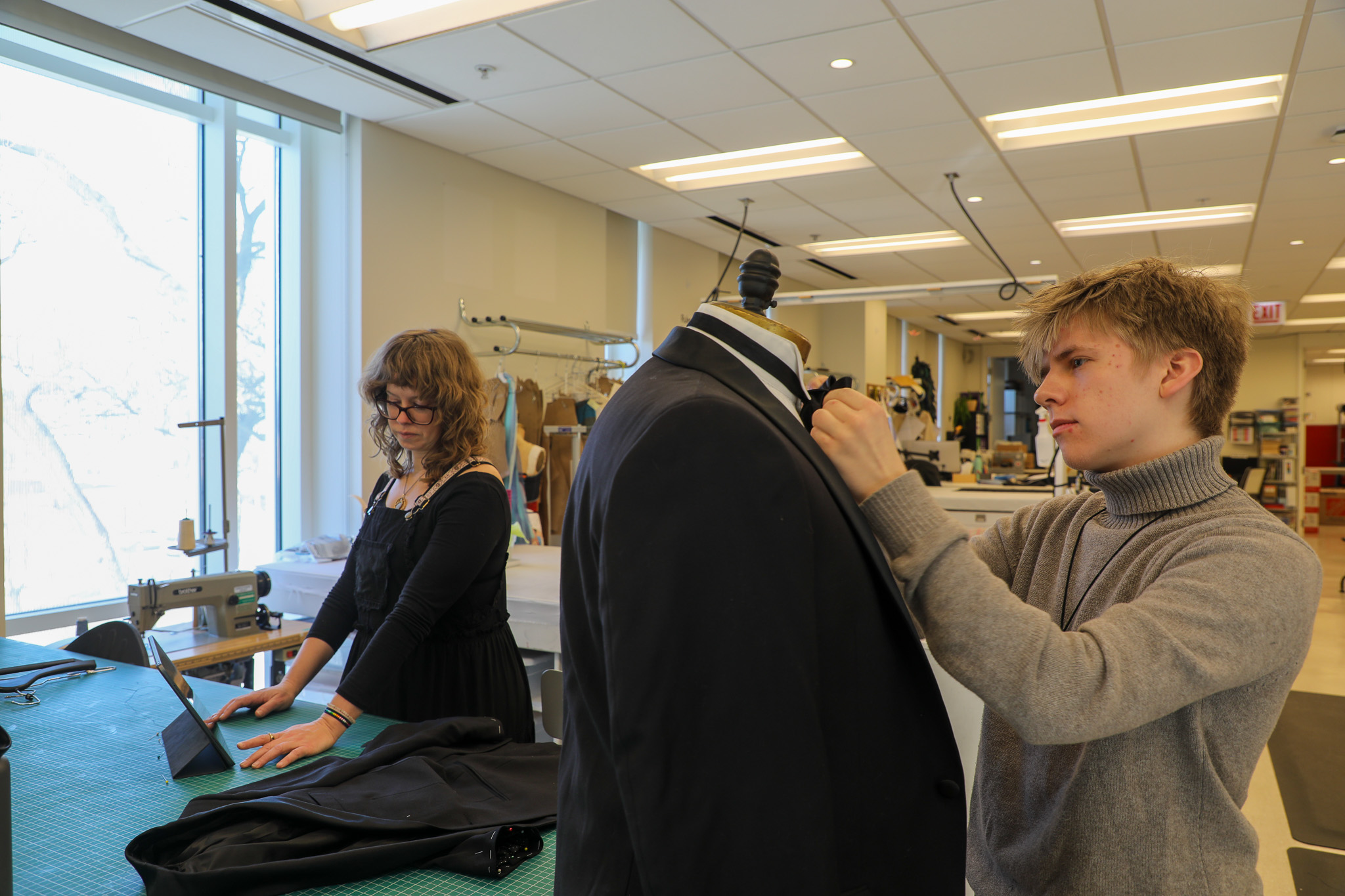 Zach Grassee and Sally Dolembo make alterations on a costume piece for 