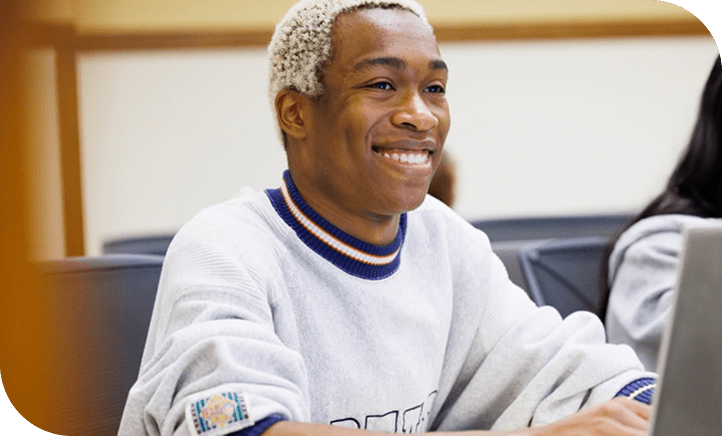 DePaul Law Student Smiling At Desk 
