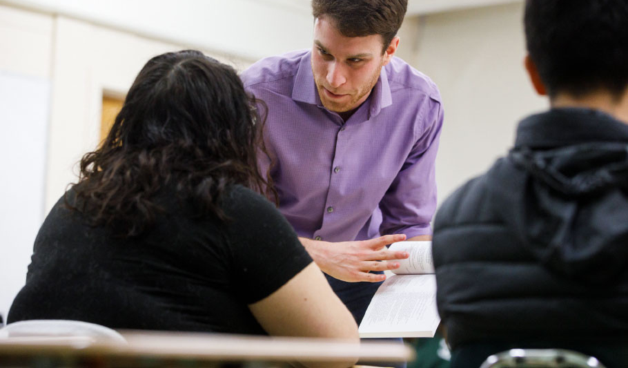 Faculty member discussing class materials with student.