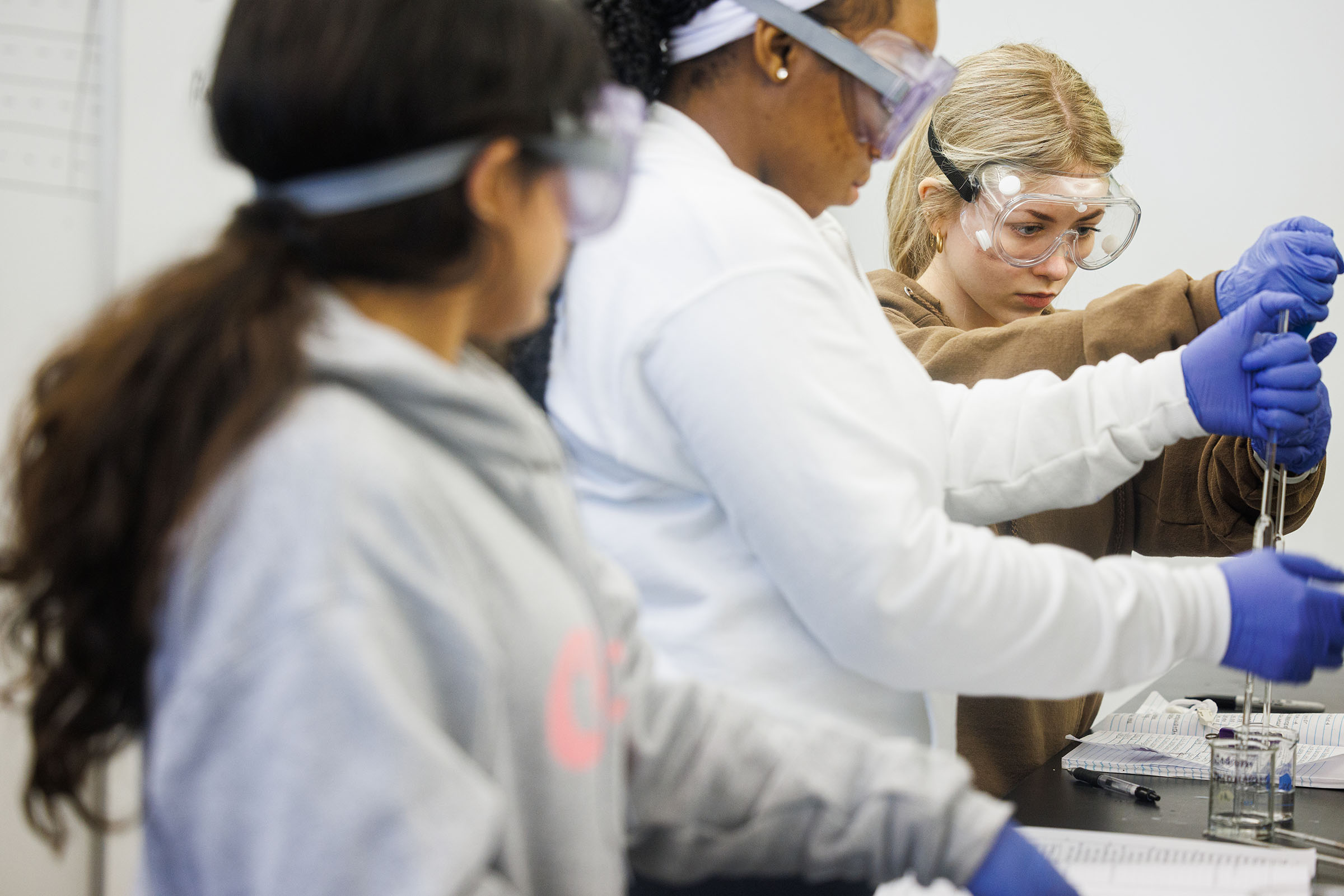 Three students in a science lab at DePaul University