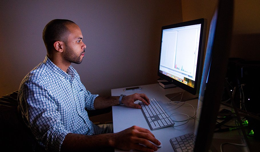 Close shot of a man using a computer