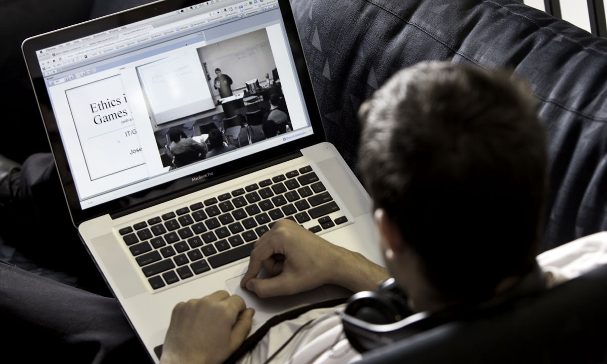 student using laptop on couch