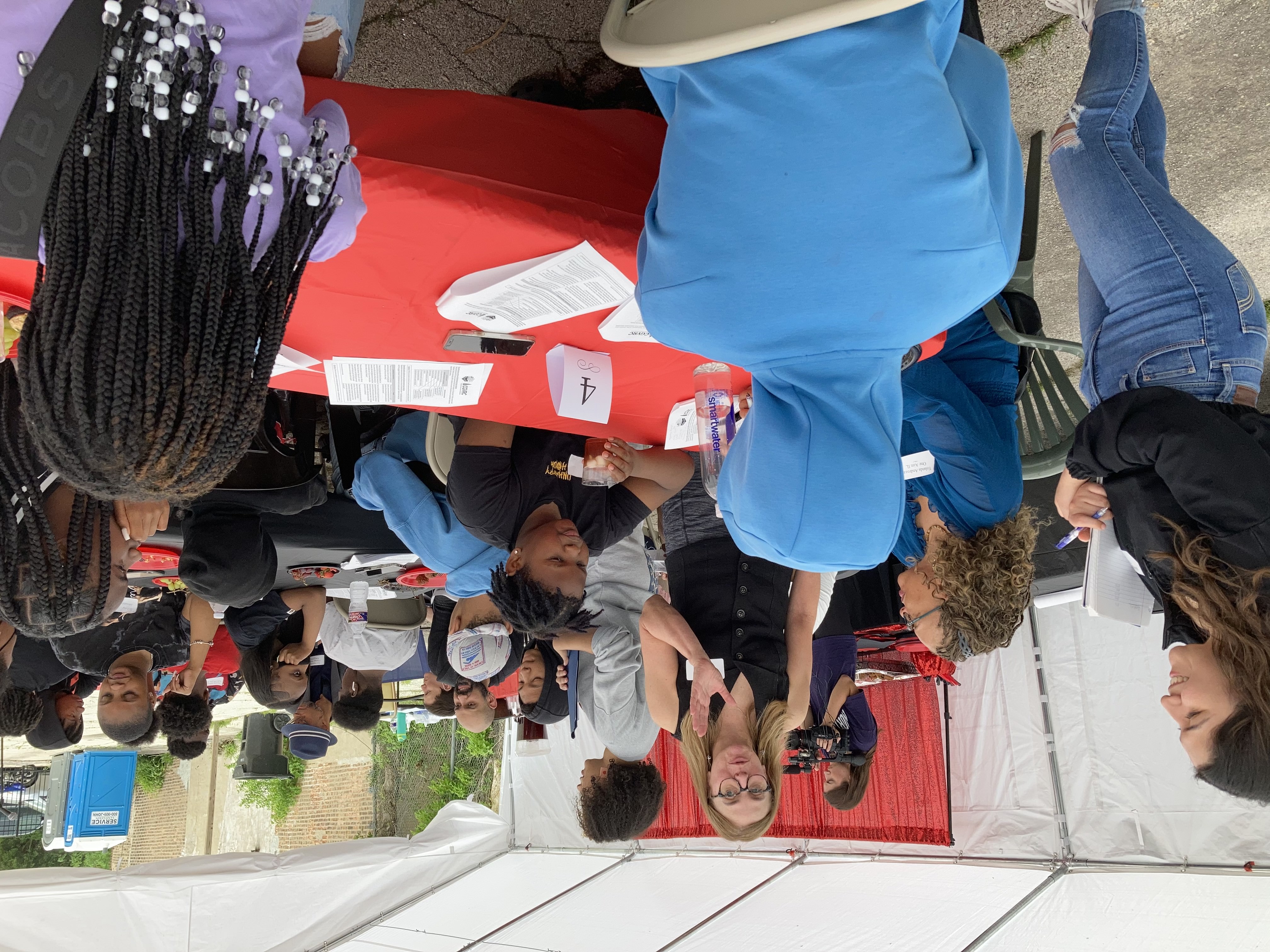 At a May 14 community forum in Roseland, Abigail Torres (standing, left), a DePaul master of public health program student and Chicago Gun Violence Research Collaborative graduate student fellow, and Julie Slezak (standing, right), also a CGVRC graduate student fellow, facilitate a group discussion on the data gathered throughout 2022. (Photo courtesy of Daniel Schober)