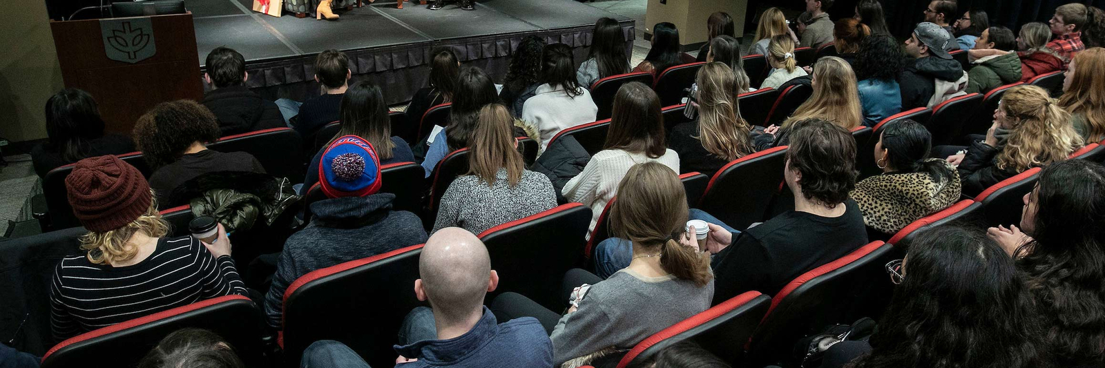 Students sitting in a crowd watching a presentation