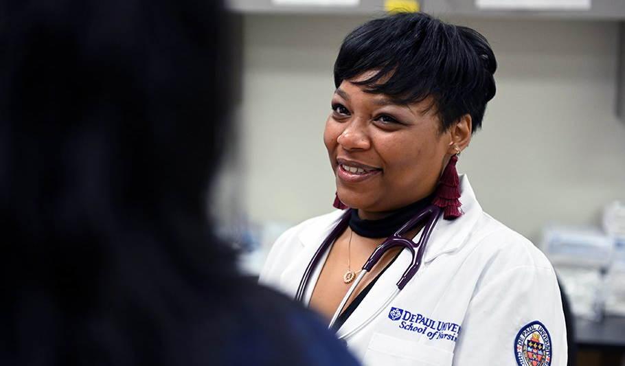 A professor smiling in lab gear.