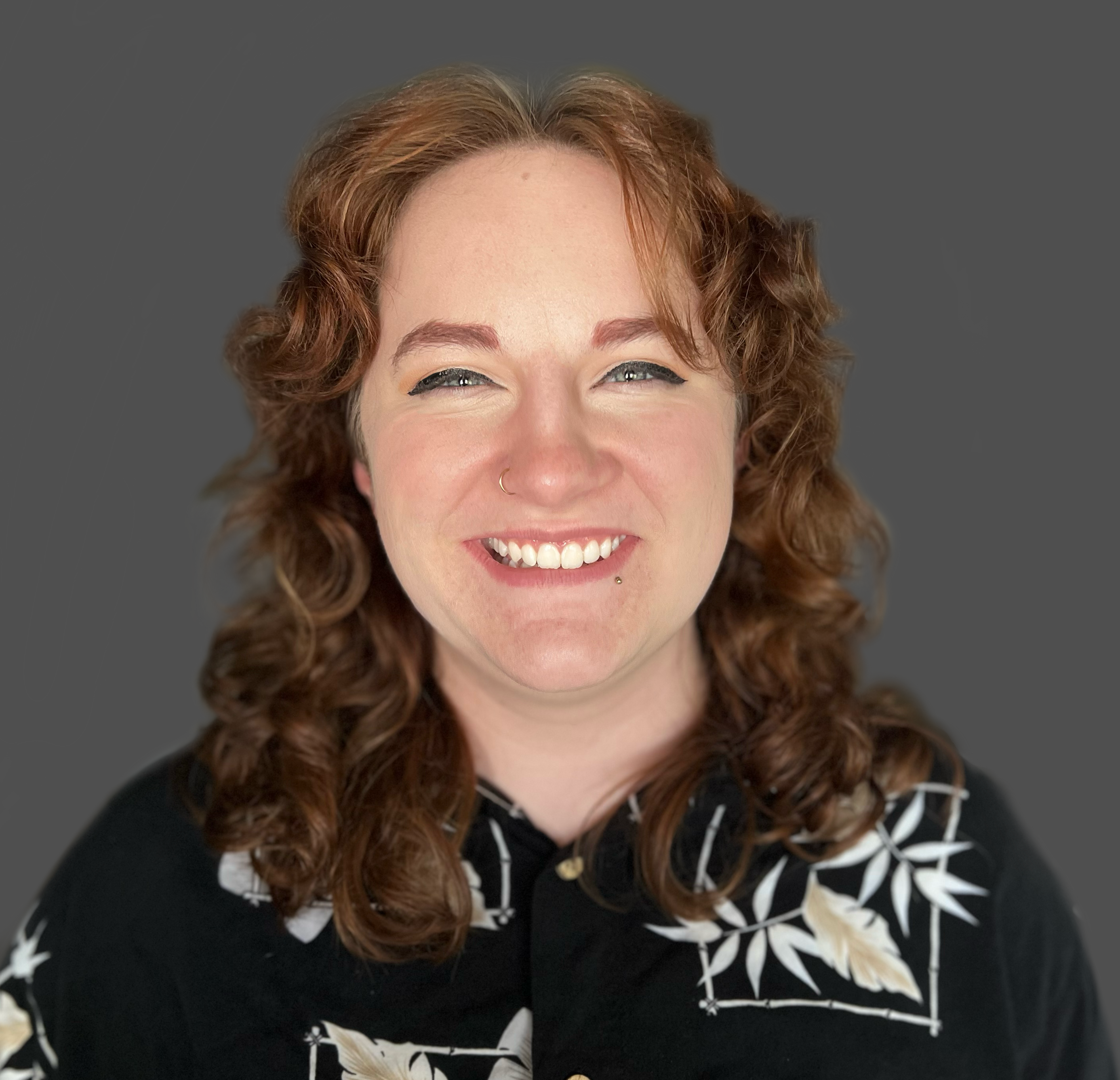 Photo of person with long brown hair smiling at camera