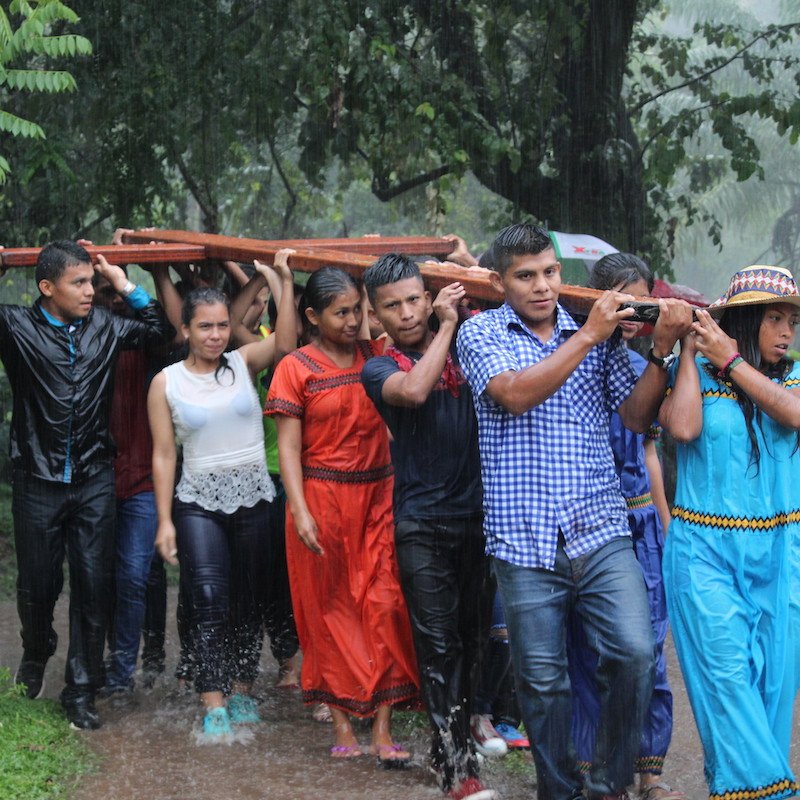 Indigenous Ngäbe youth of Panama carrying a wooden cross