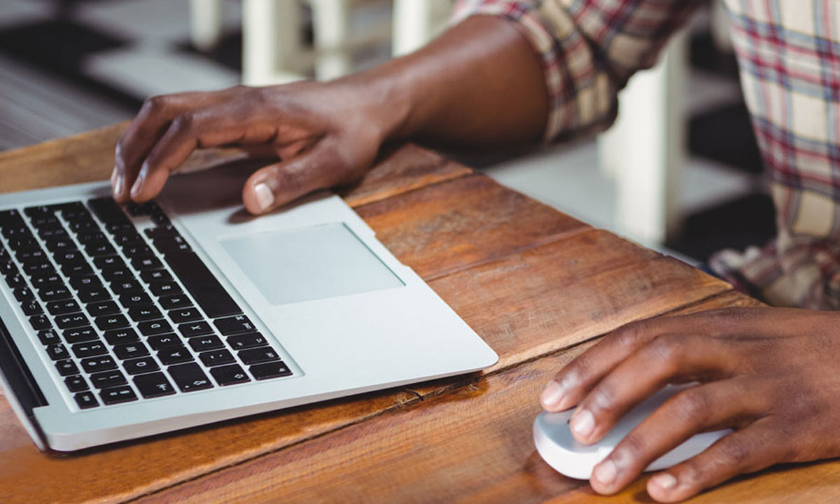 man working on laptop at coffee shop
