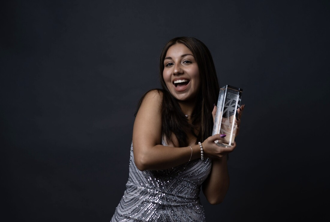Mariana Montero holding Crystal Pillar Award