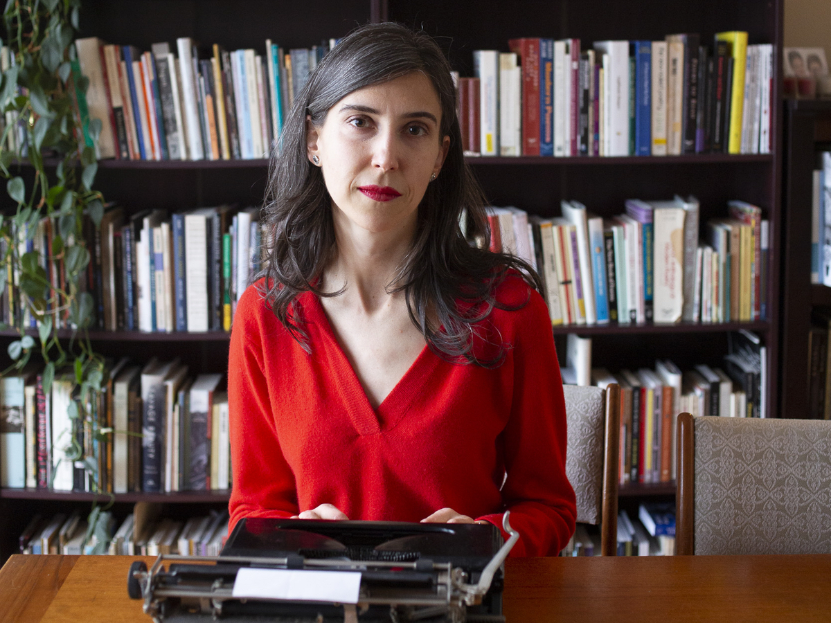 Kathleen Rooney sits behind a manual typewriter