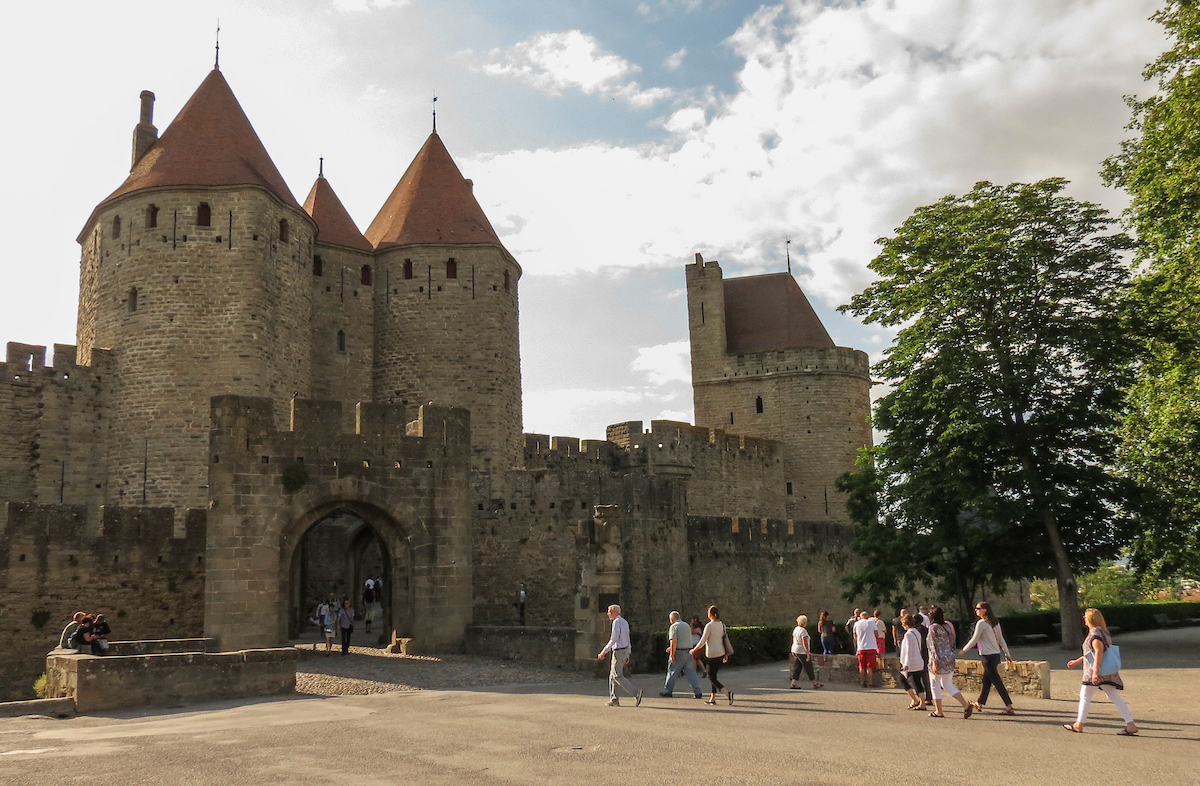 Faculty and staff walk into a castle in France.