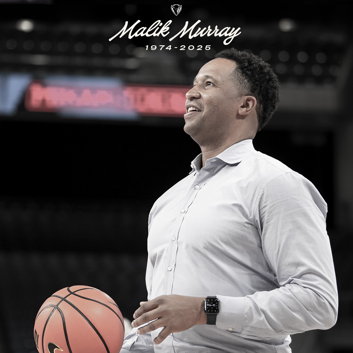 Malik Murray holding a basketball