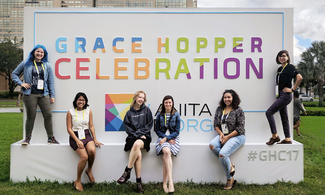 DePaul students pose in front of Grace Hopper Celebration sign