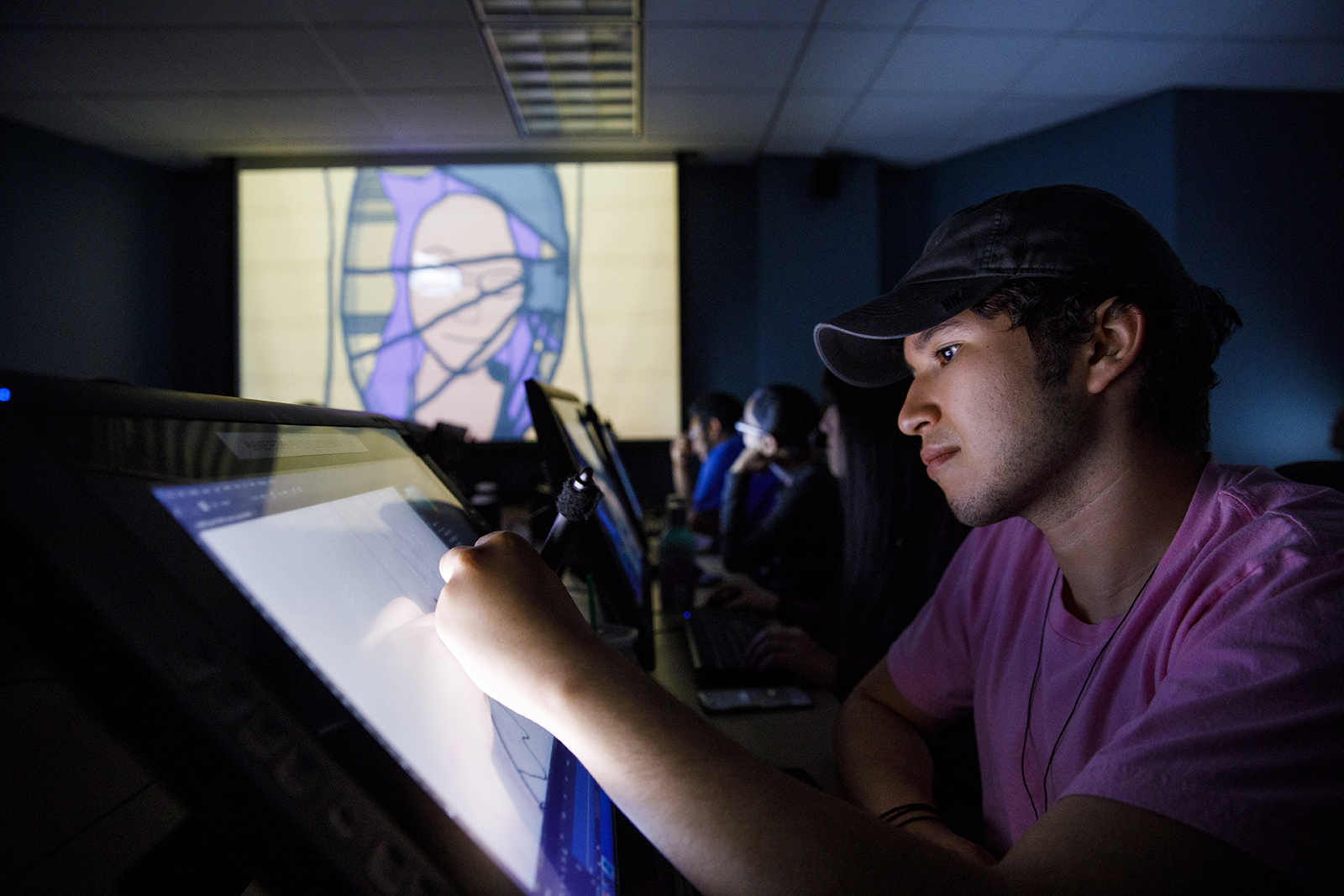 Student works on graphic design on touch screen