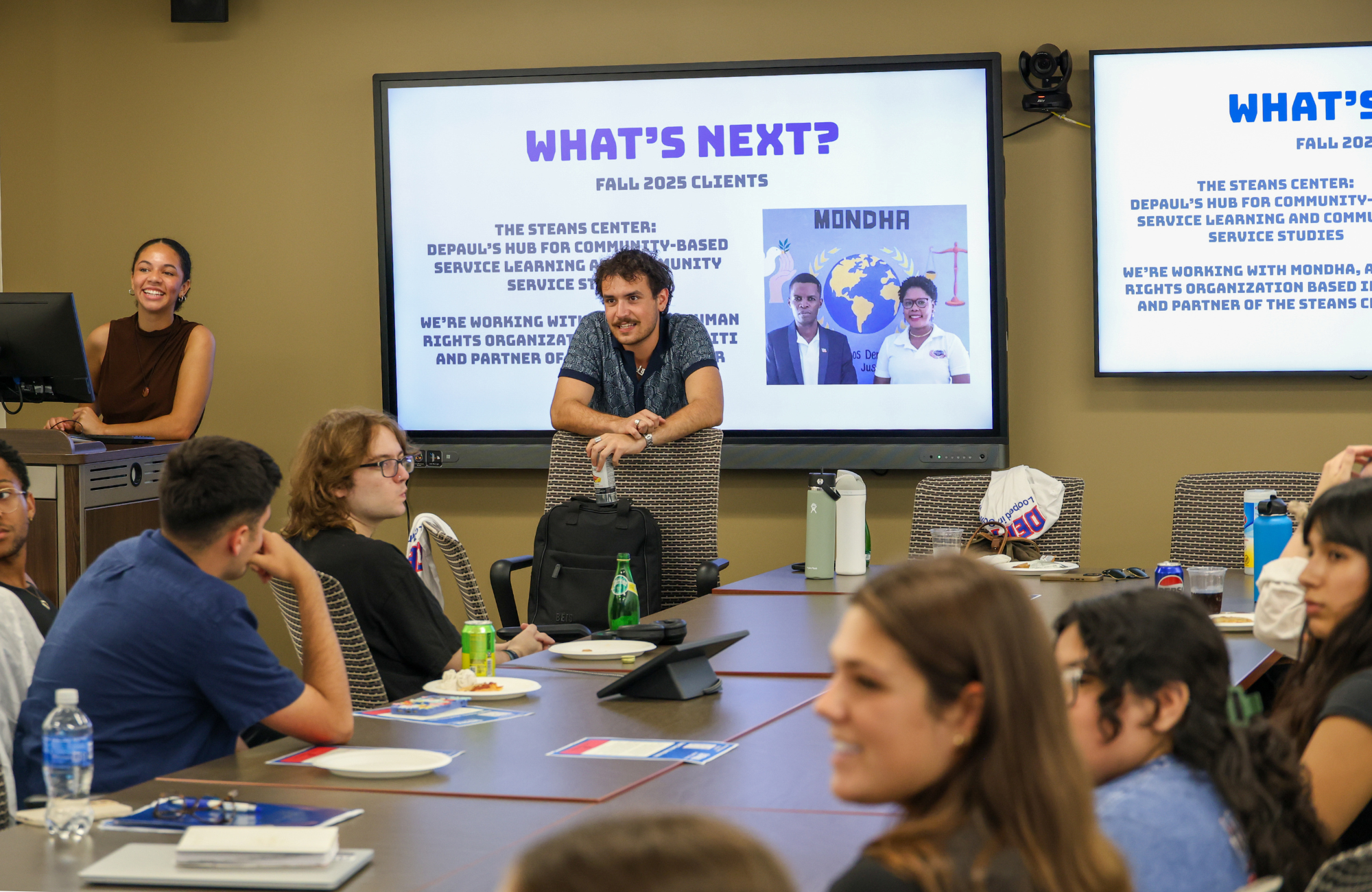 A group of students have a discussion at a conference table