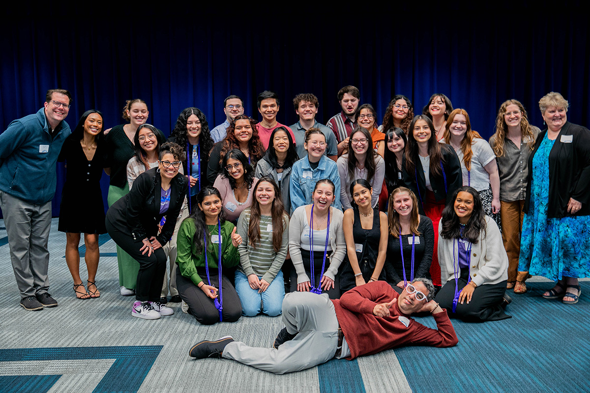 A group of students and staff stand together