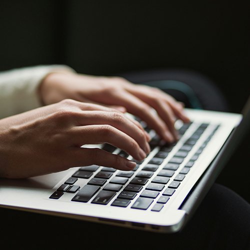 Fingers on Laptop Keyboard