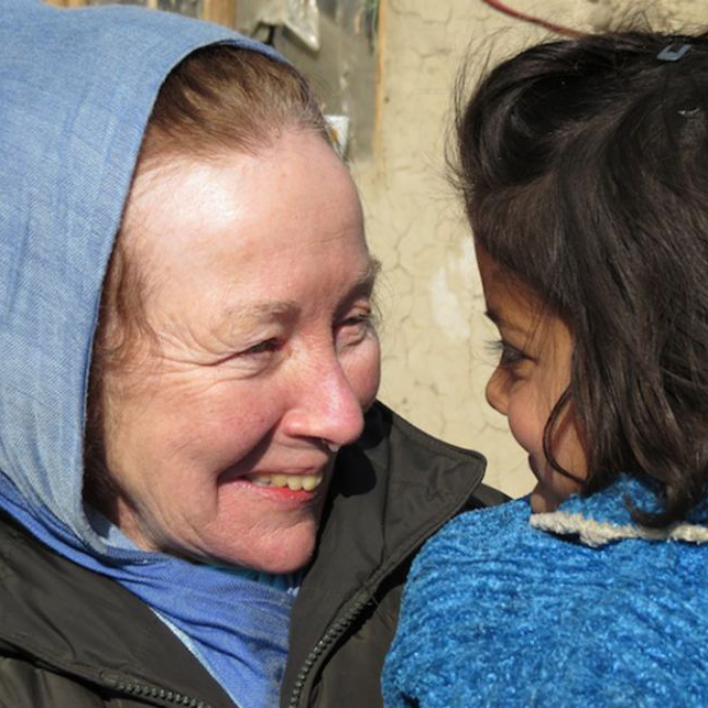 Kathy Kelly with a little girl in a Kabul, Afghanistan refugee camp.