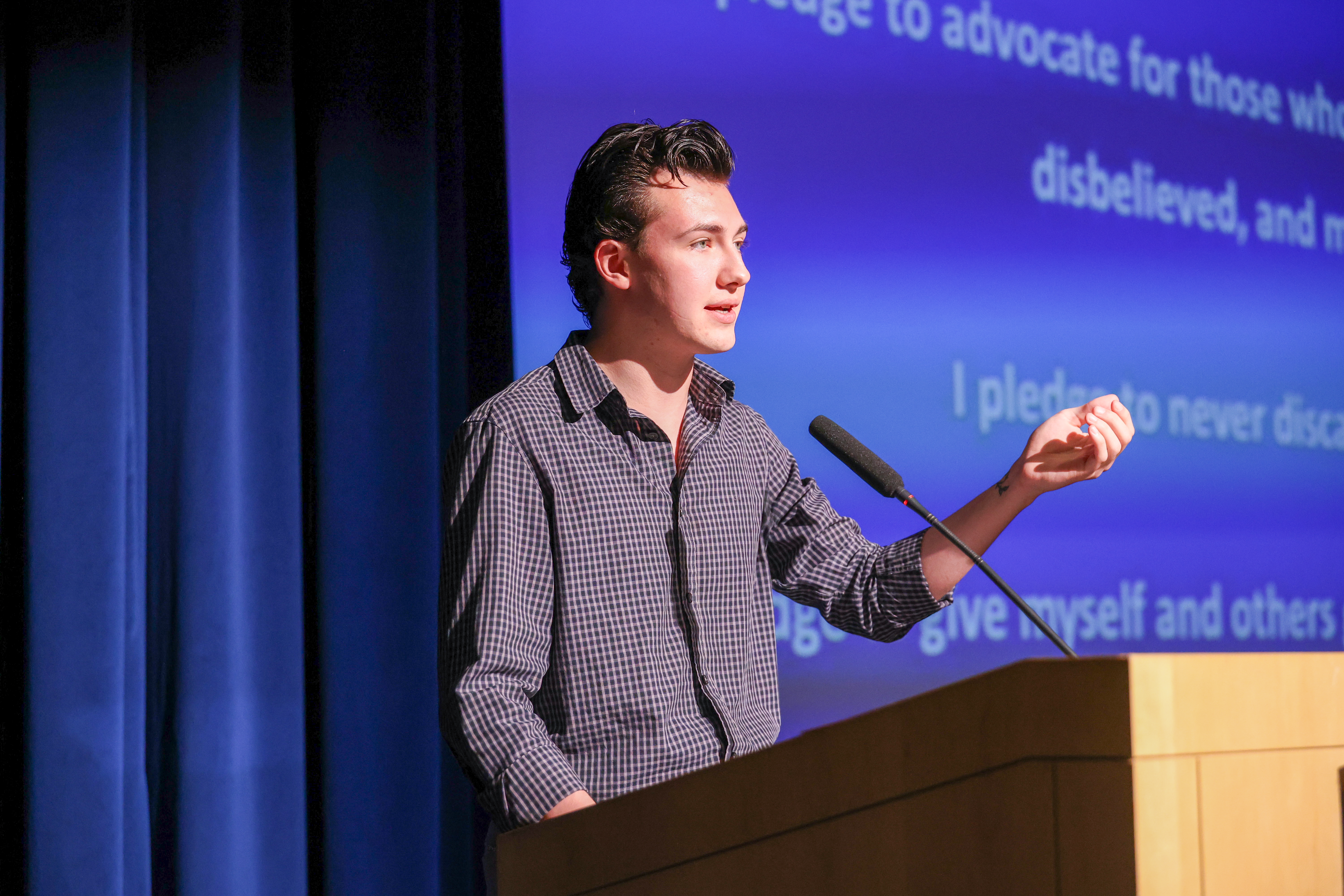 Michael Stage, a DePaul student, Bridgebuilding fellow and Catholic Campus Ministry leader, addresses the audience at "A Beacon of Light in Darkness," on Friday, April 24, 2026.