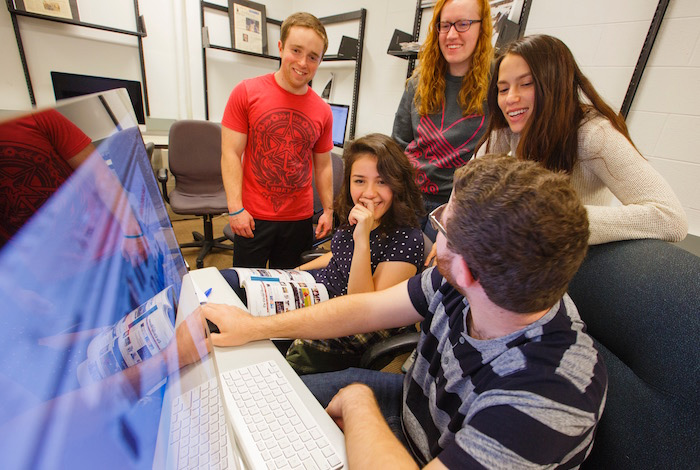 DePaulia staffers gathered around computer