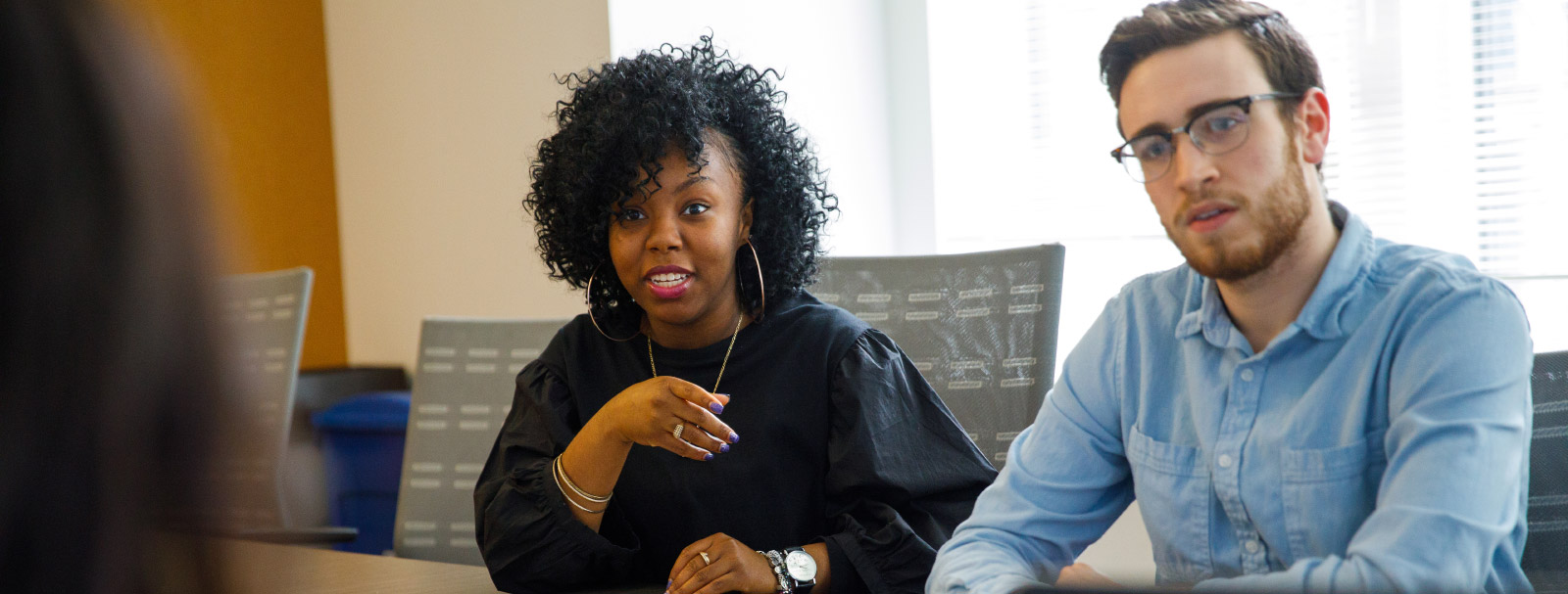 African American woman talking, Caucasian man listening