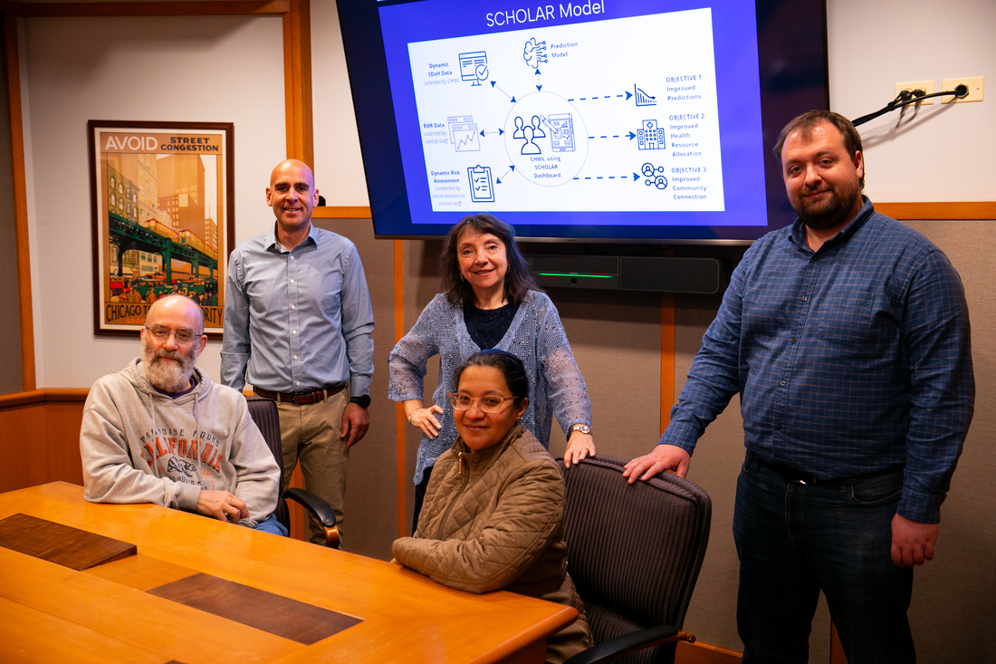 Five DePaul researchers in a conference room with monitor behind them