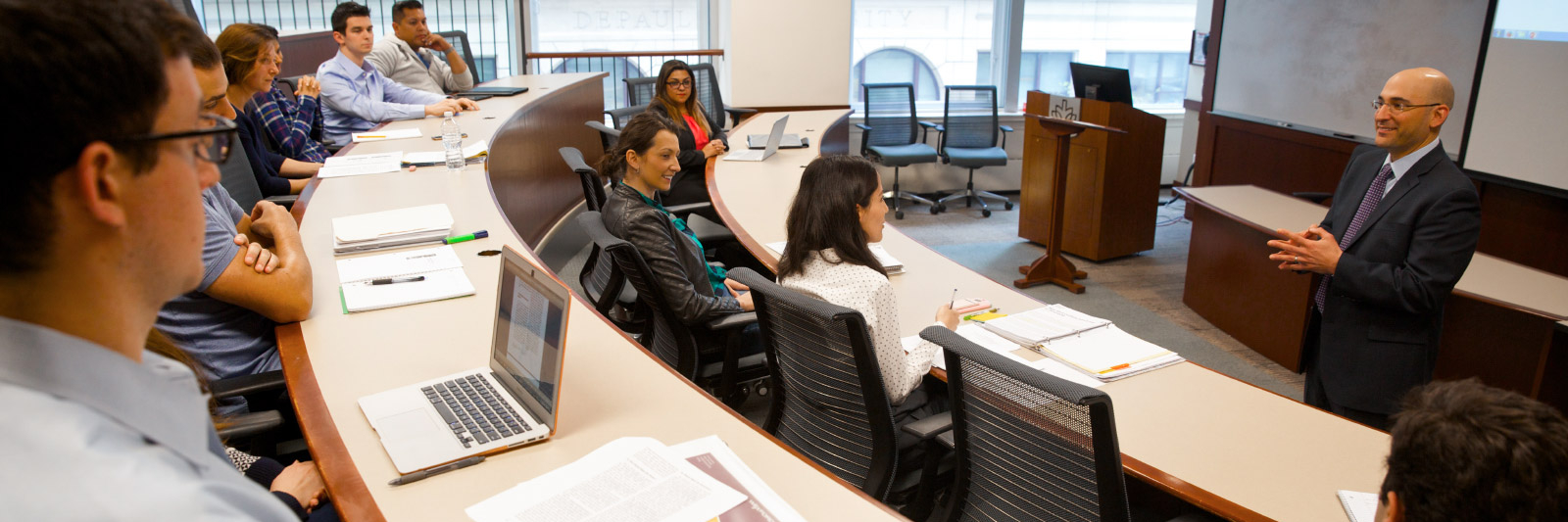 Professor lecturing to students in a classroom