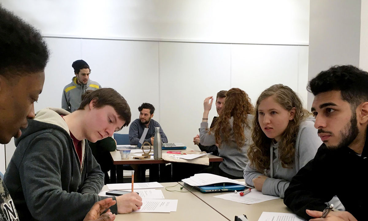 students collaborating around a desk