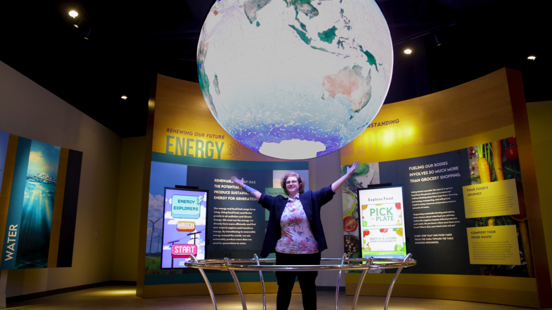 Faculty below the giant globe in the Peggy Notebaert Museum's sustainability exhibit