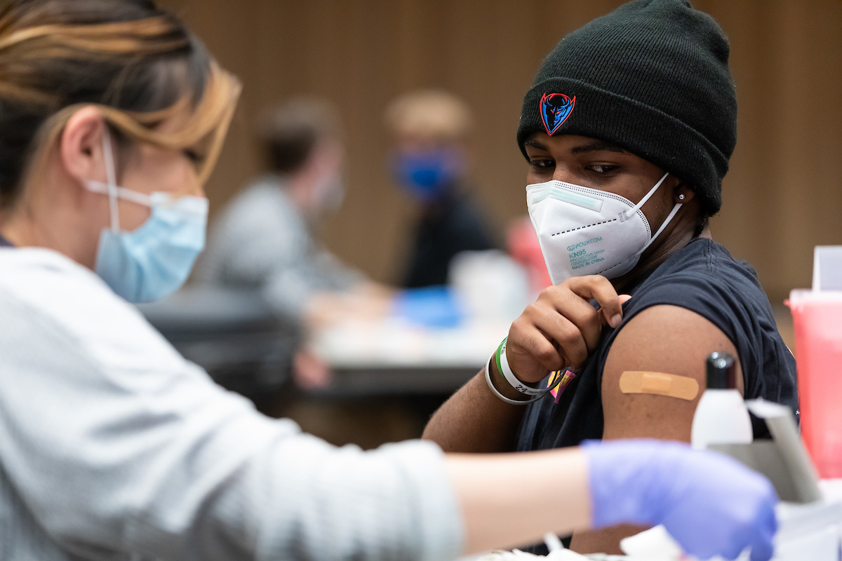 A DePaul student receives a COVID-19 vaccine.
