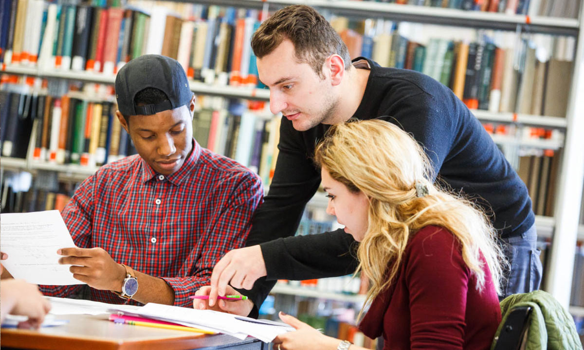 3 people looking over paperwork