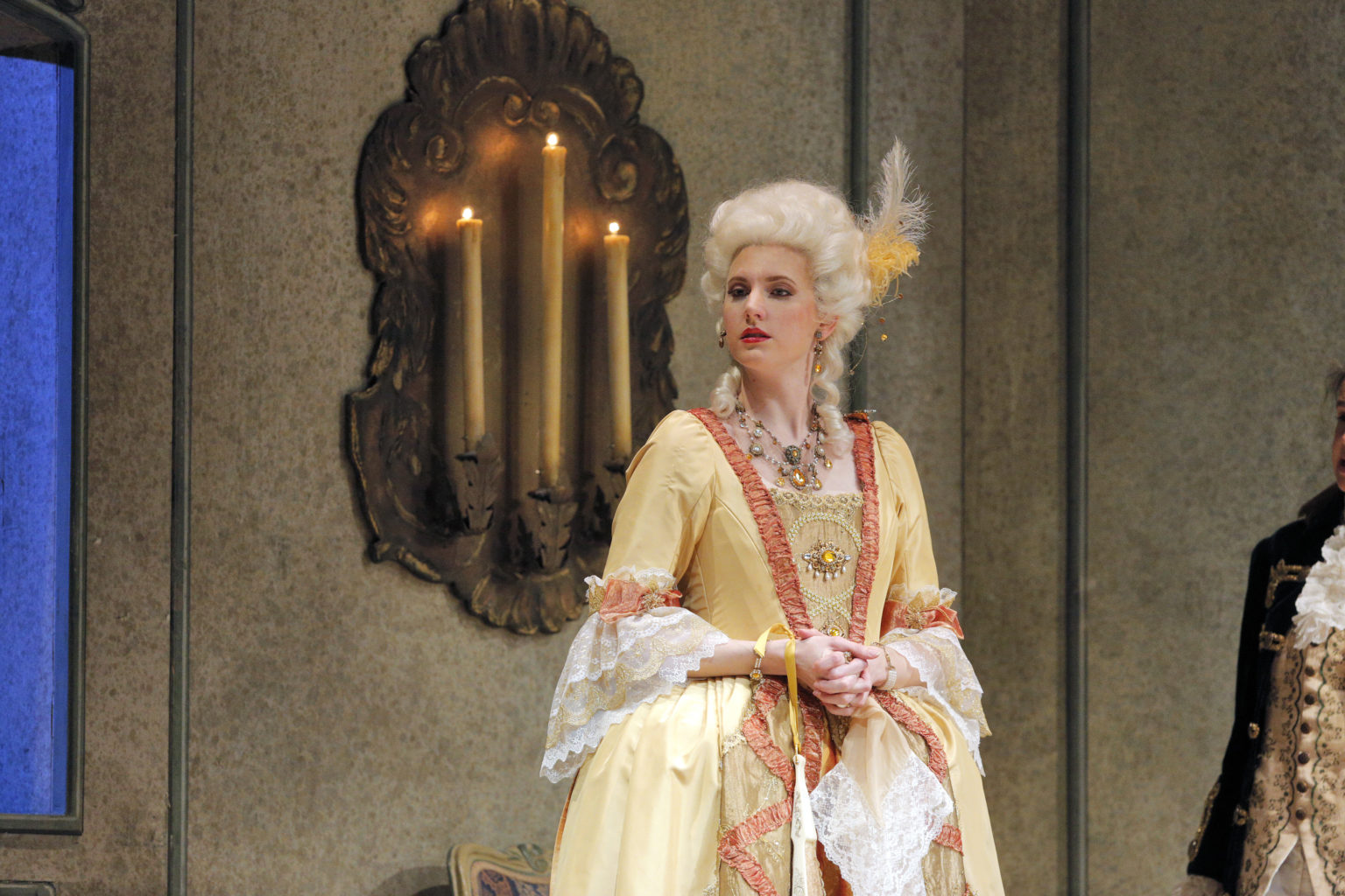 Amanda Majeski on stage and in costume with a large orange dress and a big white wig