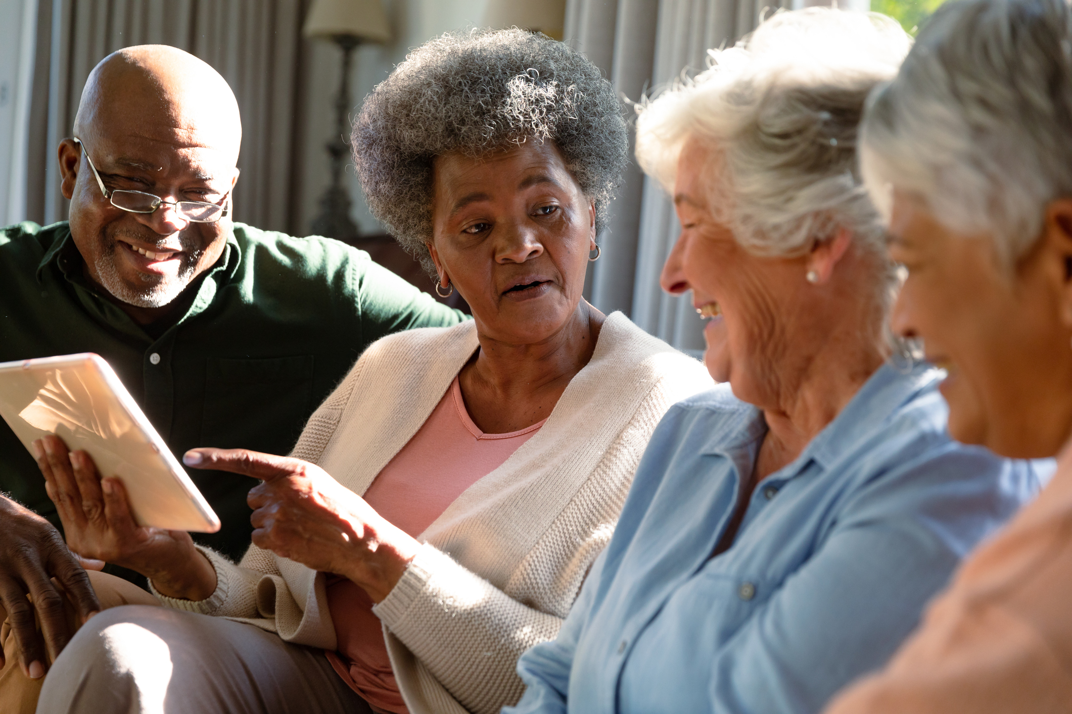 A group of older adults discuss a book