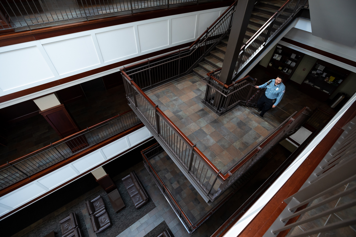 Security officer climbs steps in a deserted building