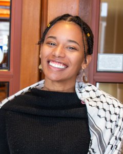 Camille Perry smiles with her head tilted slightly