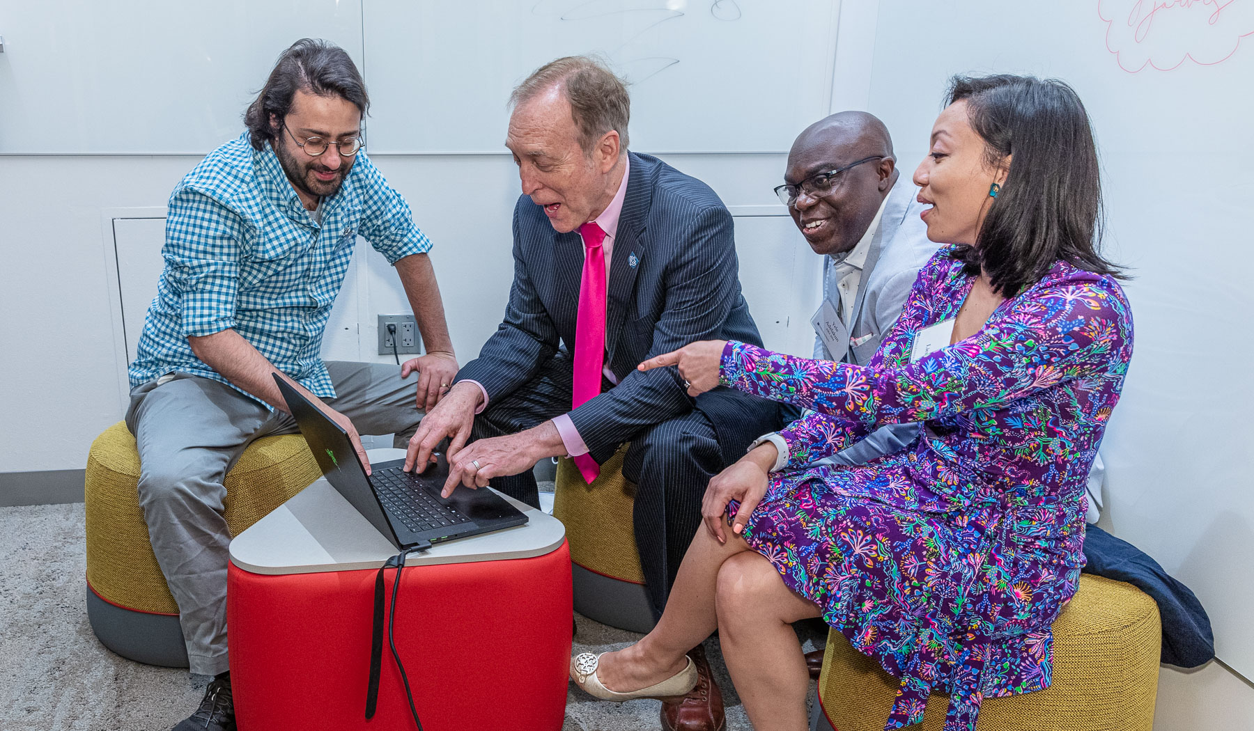 Eugene Jarvis tests a student's game in the new Jarvis Student Center for Innovation and Collaboration
