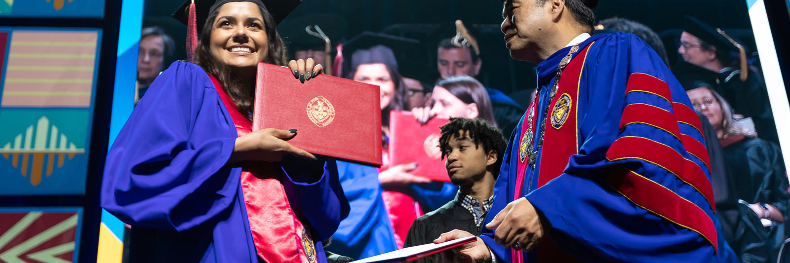 Student receives diploma at commencement ceremony