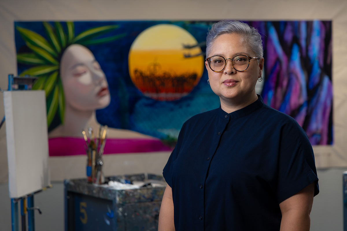 Laura Kina in front of her art