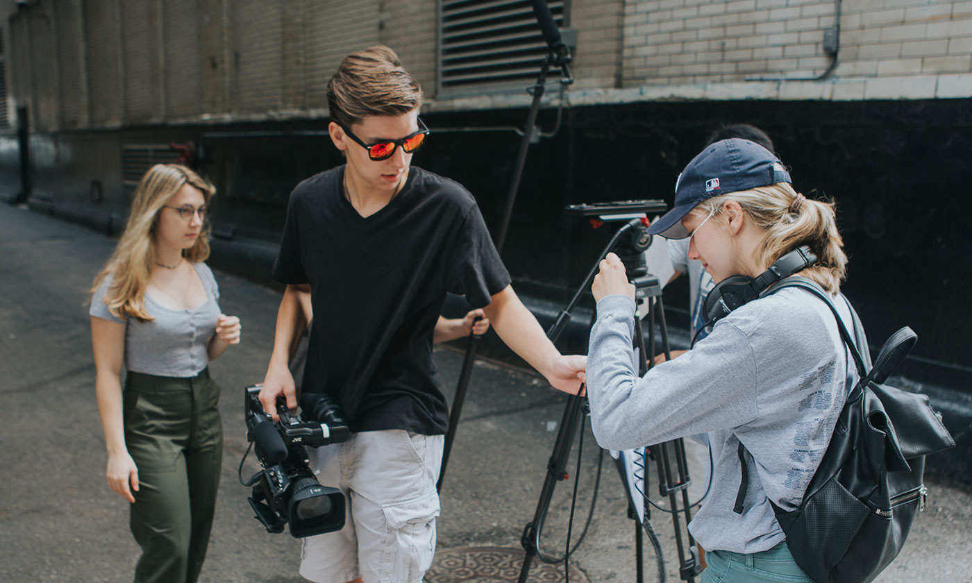 students in alley using camera