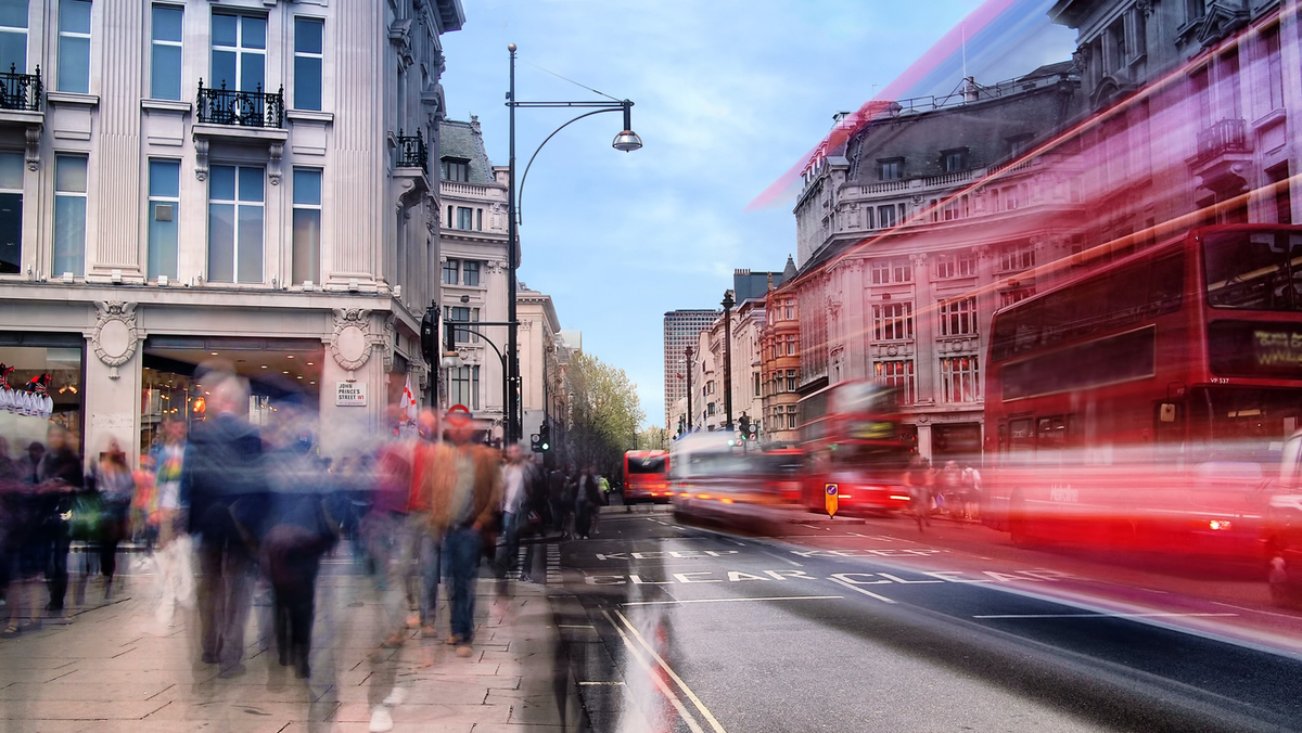 Pedestrians along a busy city street