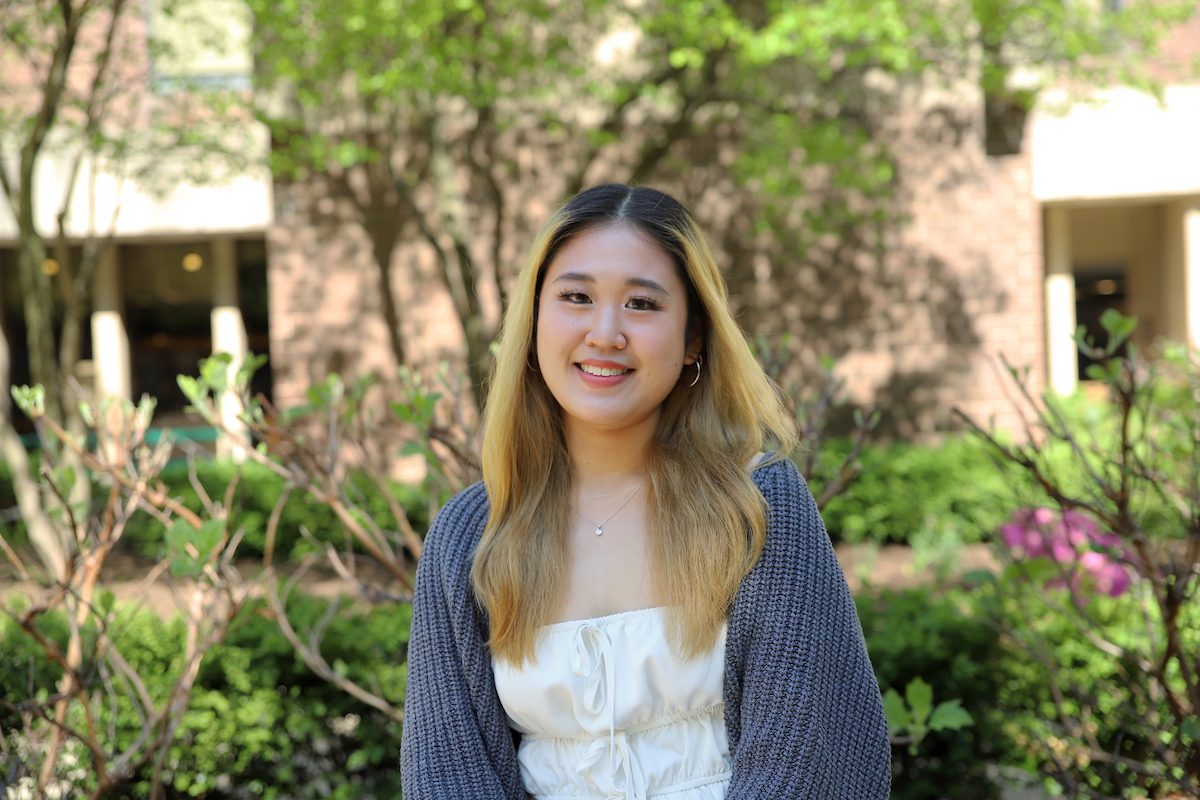 Amanda Wijaya sits outside in DePaul's quad