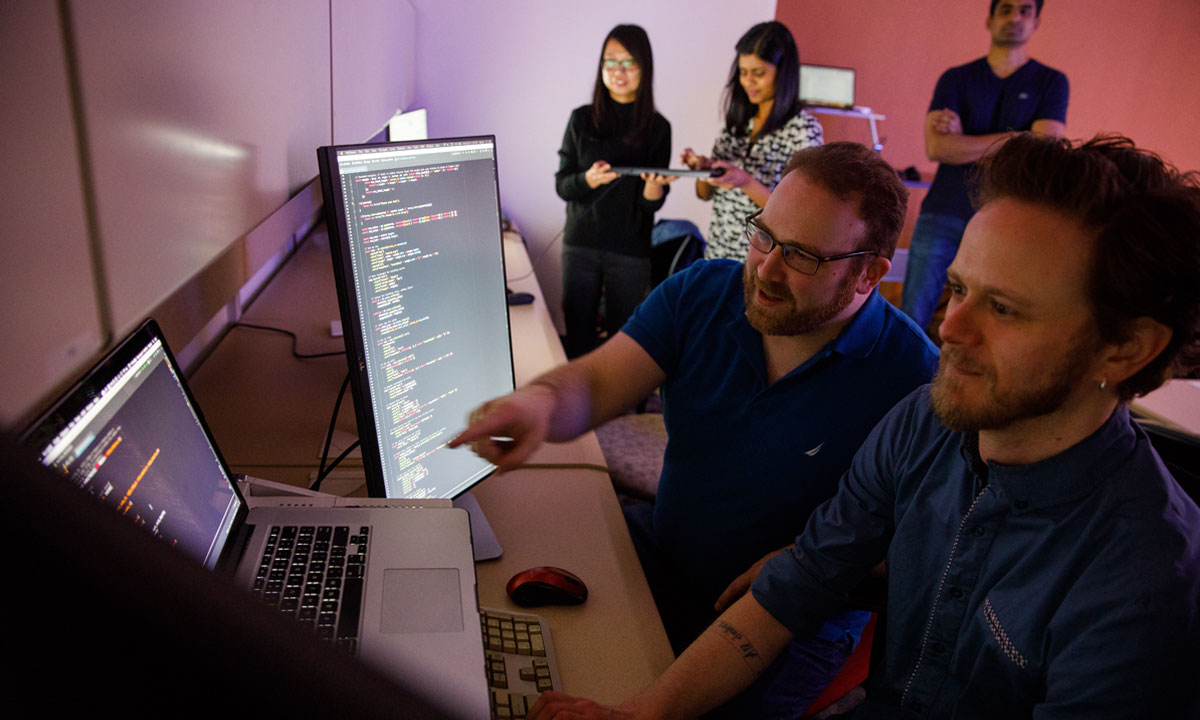 Students work together in front of a computer in the DePaul School of Computing