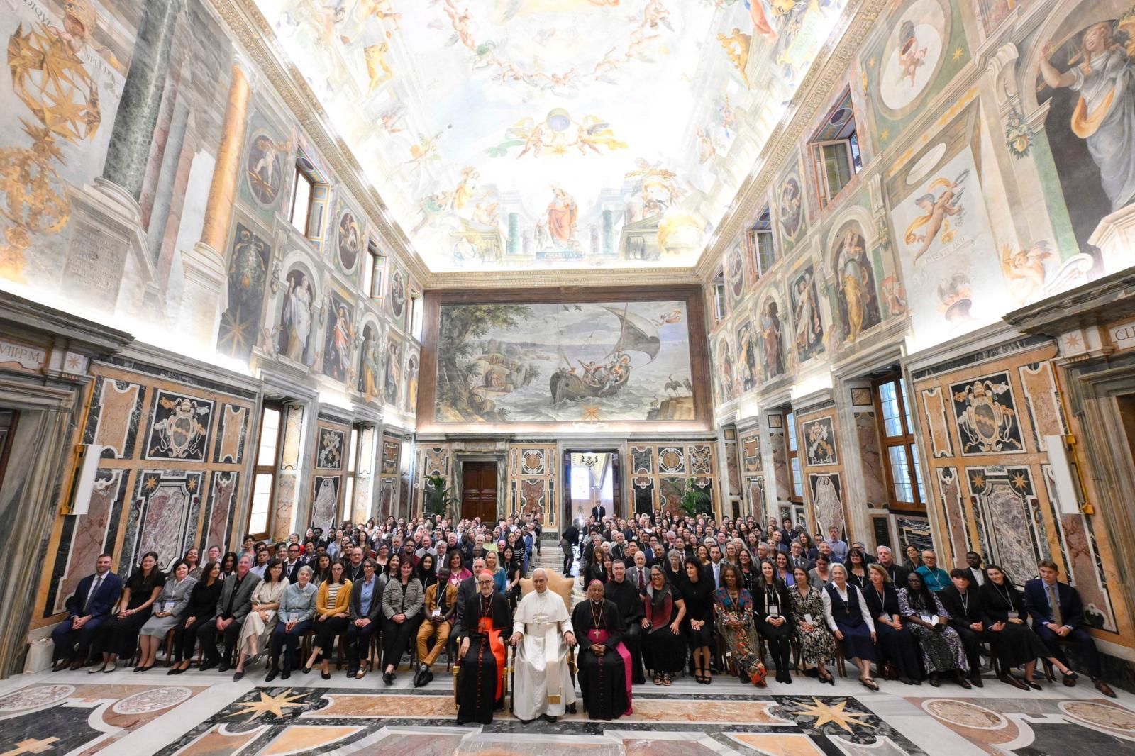 A group poses with Pope Leo XIV at the Vatican