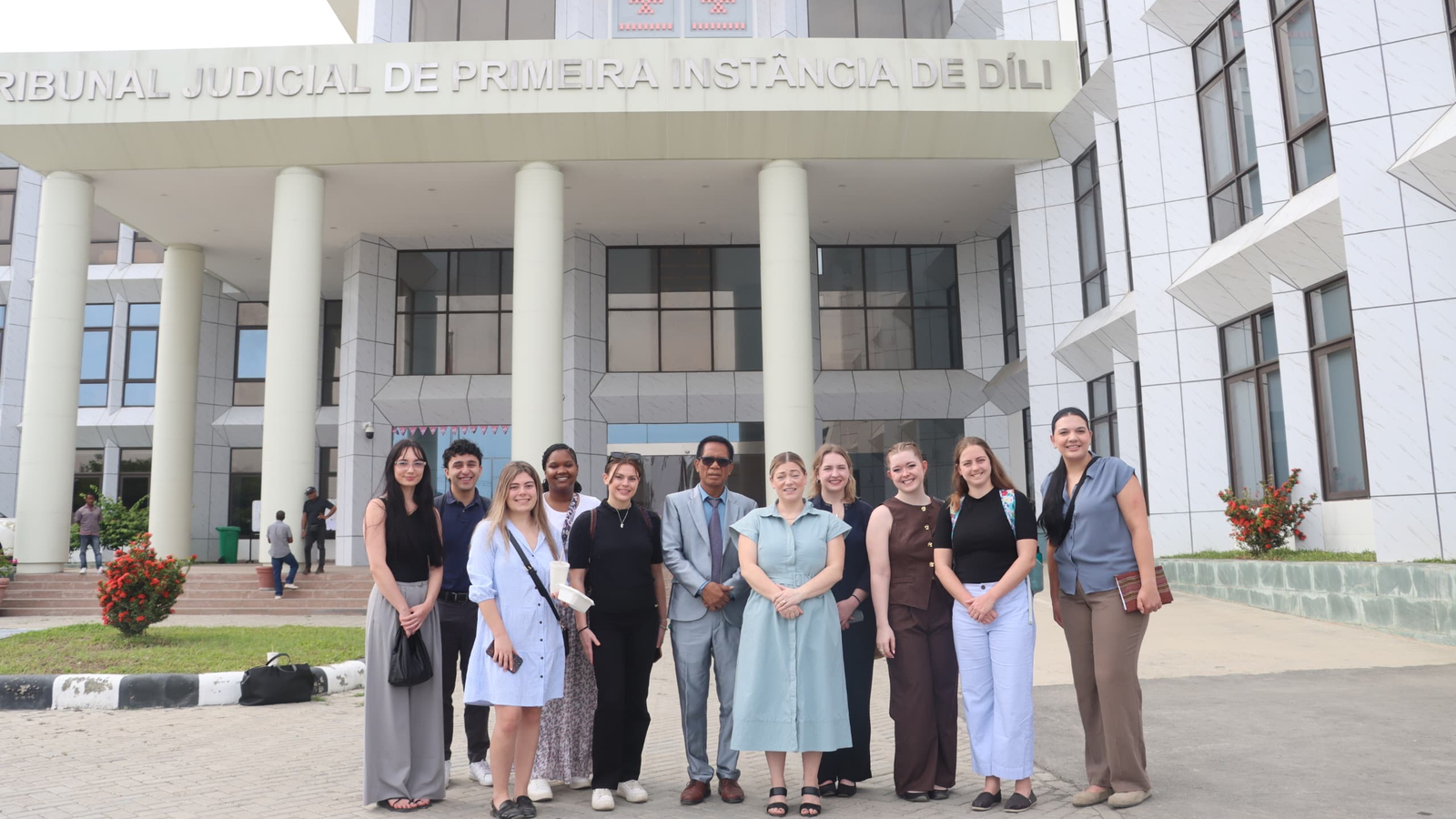 Students in the International Human Rights Law Clinic standing in front of a building in Timor-Leste
