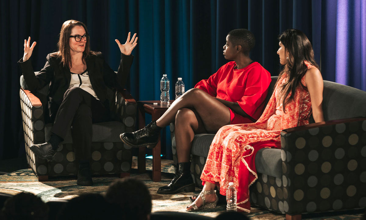 3 ladies talking on stage