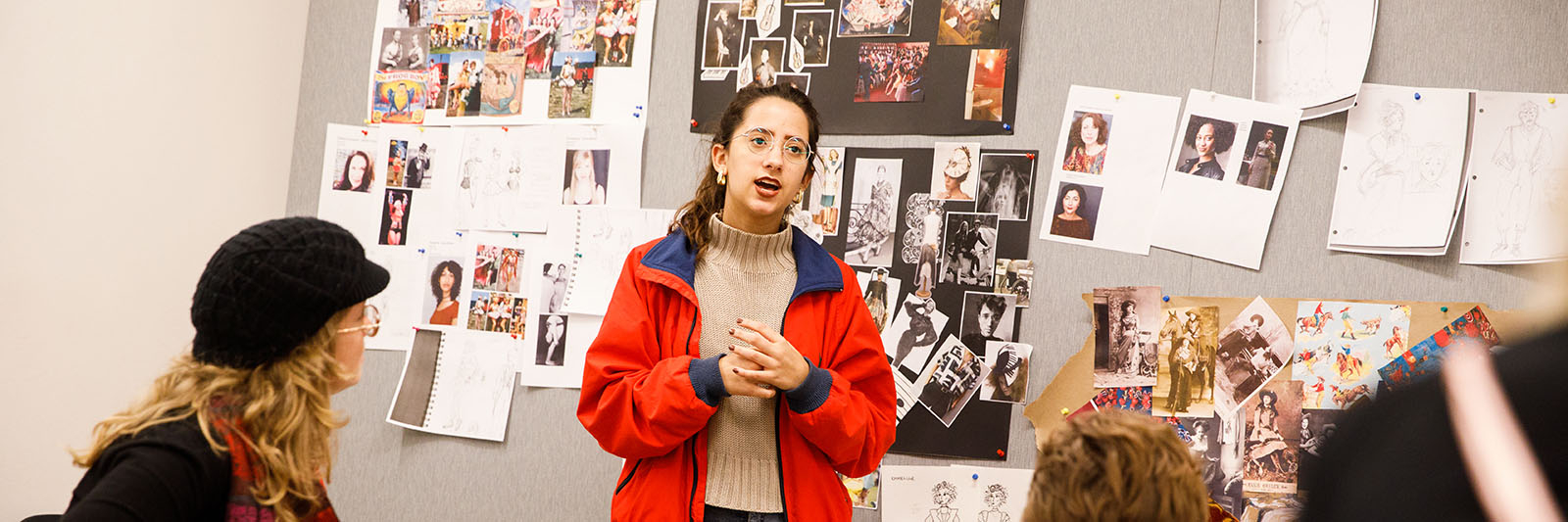 A Costume Design student presents their creations in class.
