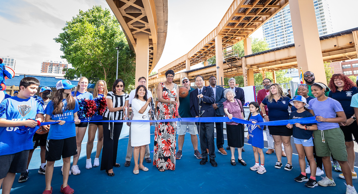 Group cutting ribbon on Lin Park basketball court