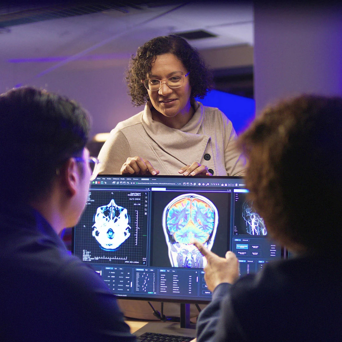 Computer Science teacher and students reviewing digital health imagery