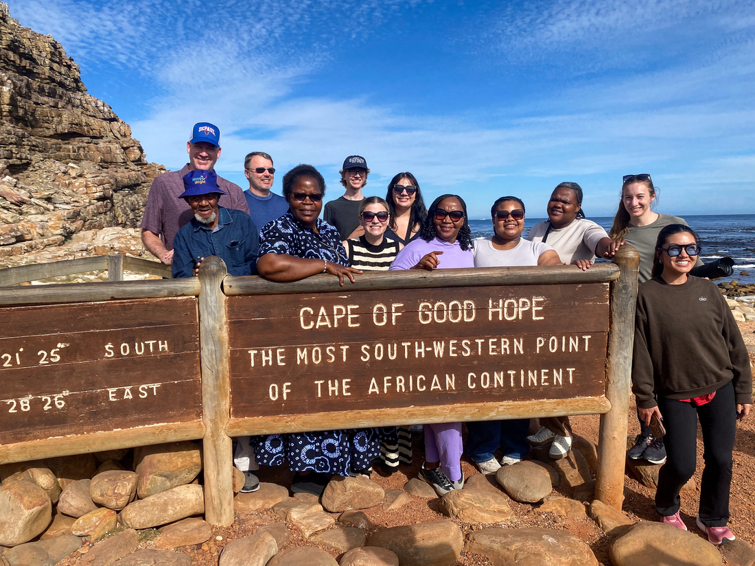 DePaul folks in front of Cape of Good Hope sign.