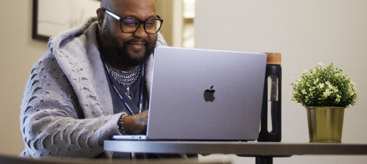 DePaul students writing notes on a blackboard
